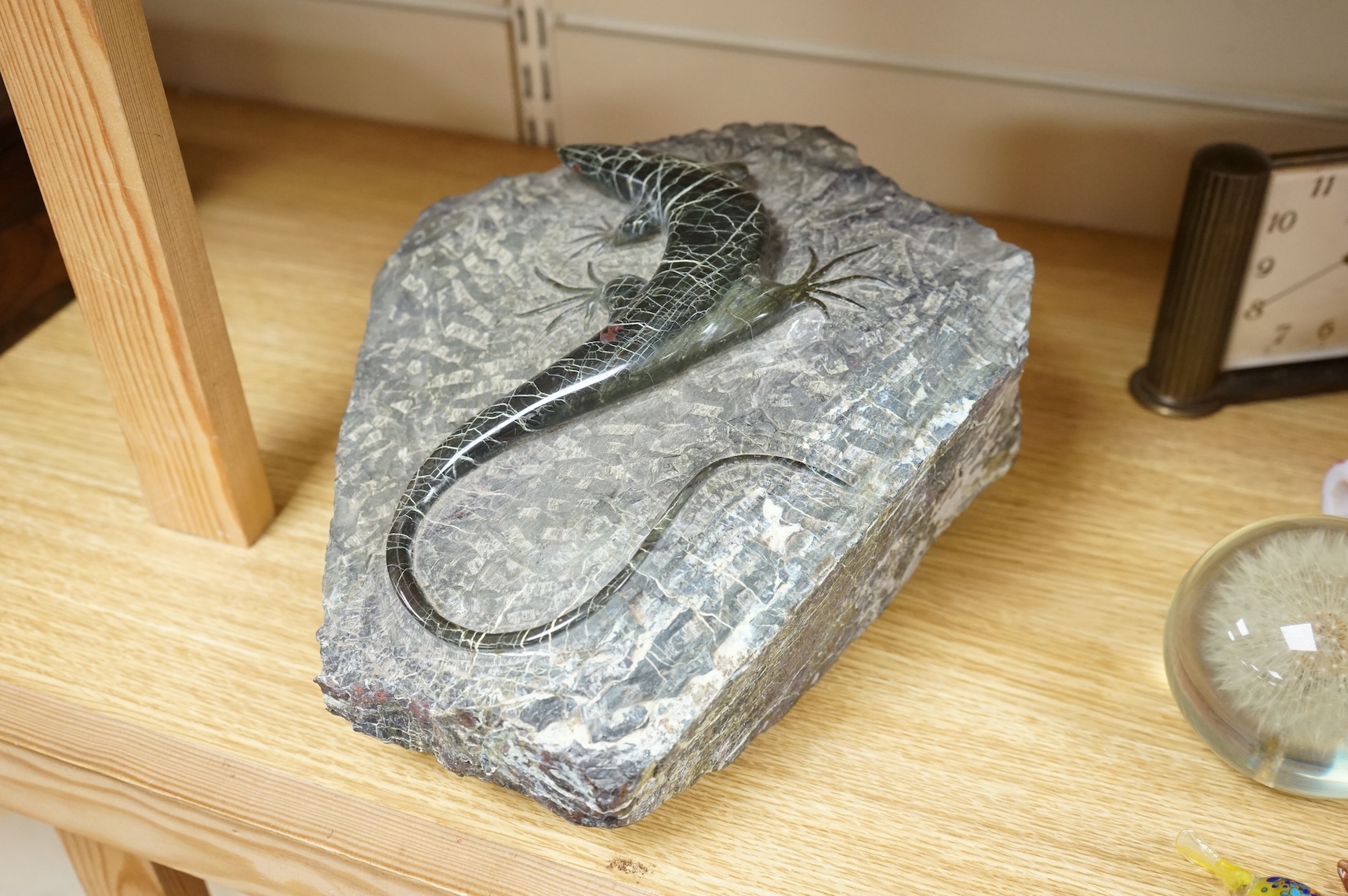 A carved green granite lizard, 27cm wide